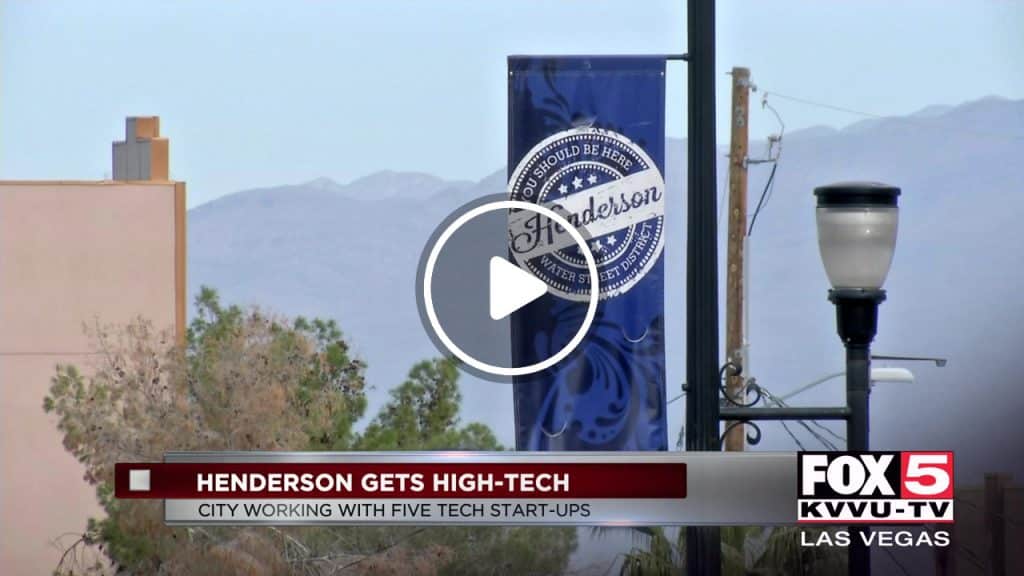 Henderson Gets High Tech News Caption with City Background